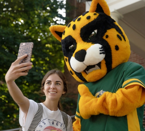 student with jaguar mascot