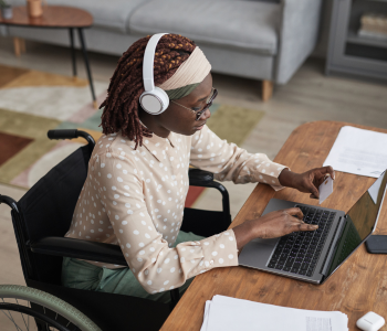 women in a wheel chair working on a computer