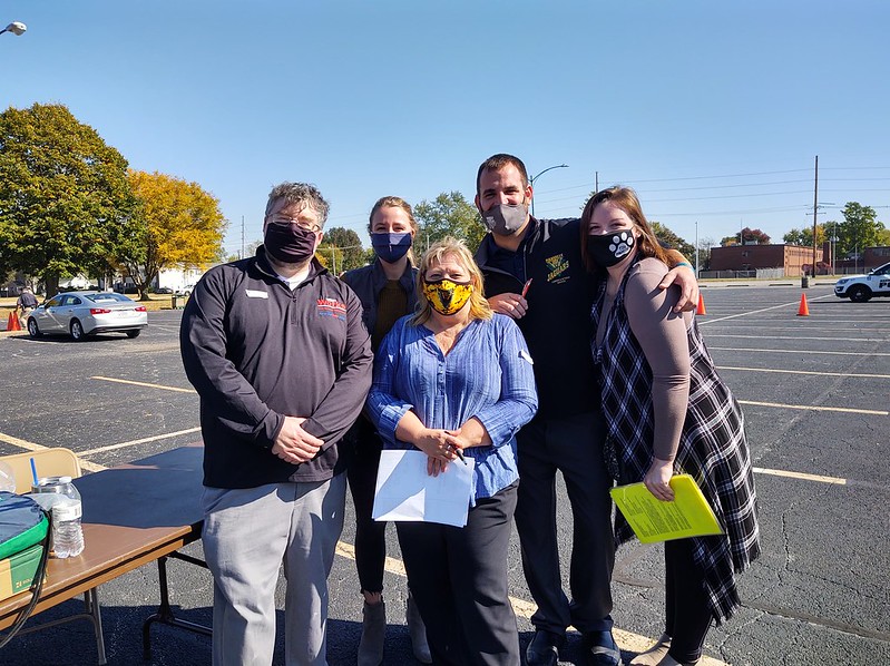A group of professionals wearing masks, in a parking lot for the 2020 Job Fair