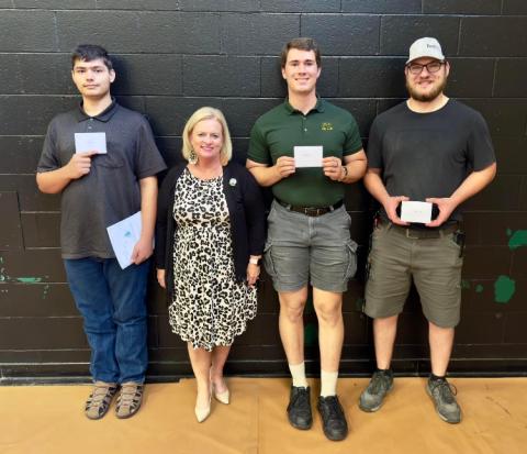 PHOTO: Donor Amy Thompson with Connor Courson, Tyson Reining, and Alexander Ritchie, recipients of the Colton John Wright Scholarship, at the 2024 DACC Foundation Honors program.